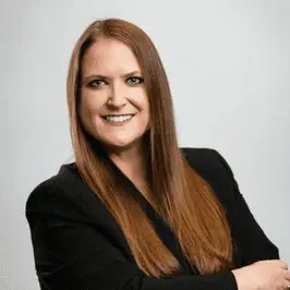 A woman wearing black dress smiling at the camera